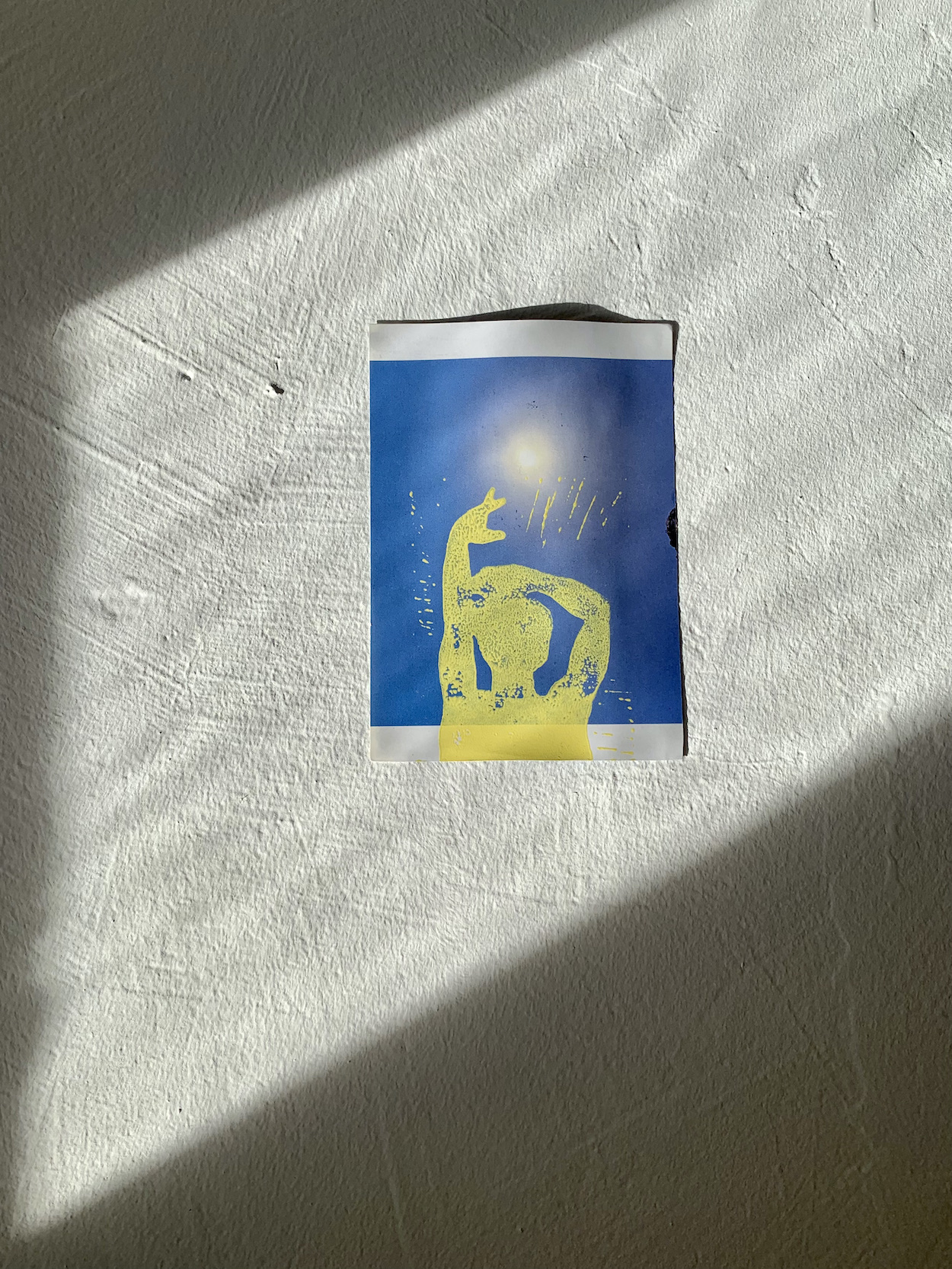 A yellow linoleum print on a blue landscape